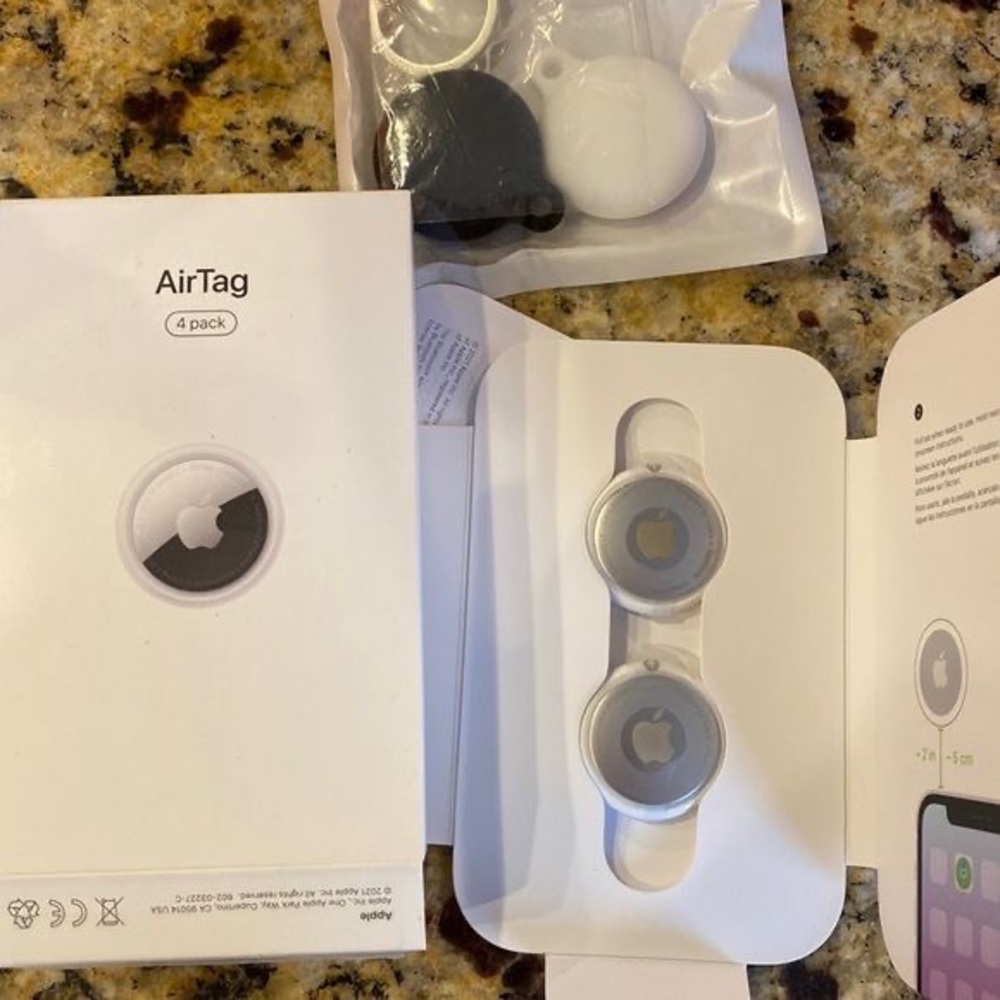 2 apple airtags, and cases